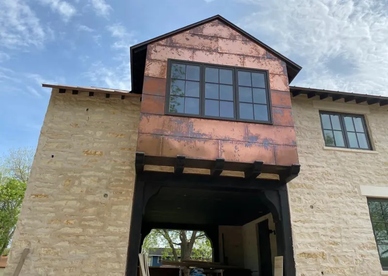 Copper metal panel facade on a stone building for Roof Repair in Pelham Manor