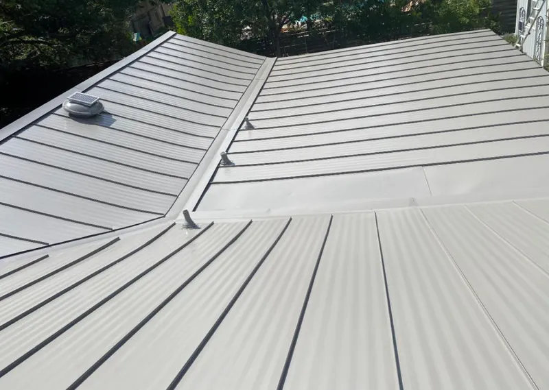 Solar attic fan installed on a metal roof for Roof Ventilation in Pelham Manor